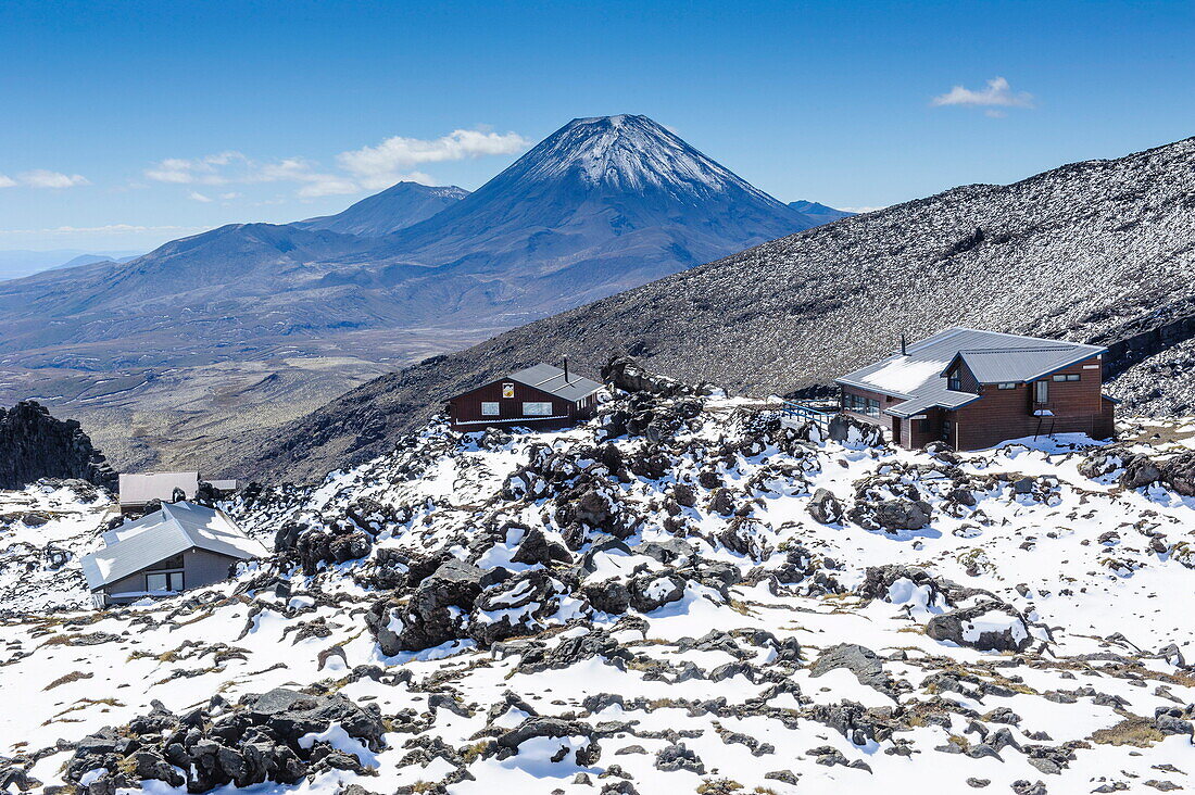 View from Mount Ruapehu of Mount Ngauruhoe with a ski cottage in the foreground, Tongariro National Park, UNESCO World Heritage Site, North Island, New Zealand, Pacific