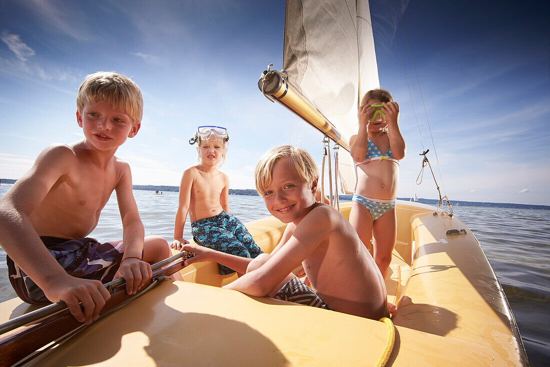 Children in a sailing boat on lake Starnberg, Upper Bavaria, Bavaria, Germany