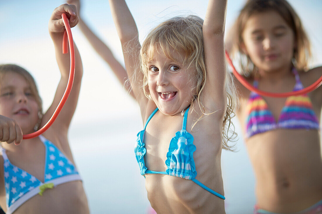 Three girls with fruitgum sticks, lake Starnberg, Upper Bavaria, Bavaria, Germany