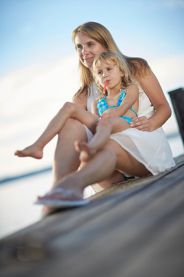 Mother and daughter on a jetty at lake Starnberg, Upper Bavaria, Bavaria, Germany