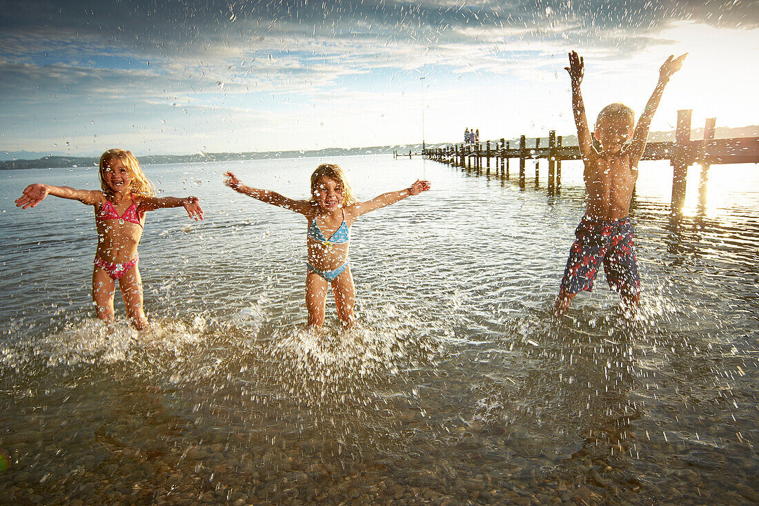 Children playing in lake Starnberg, Upper Bavaria, Bavaria, Germany