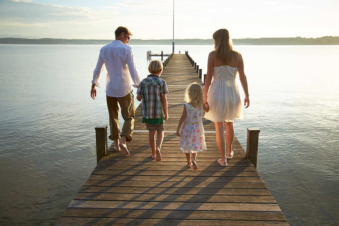 Family on a jetty at lake Starnberg, Upper Bavaria, Bavaria, Germany