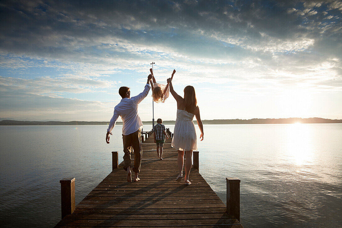 Family on a jetty at lake Starnberg, Upper Bavaria, Bavaria, Germany