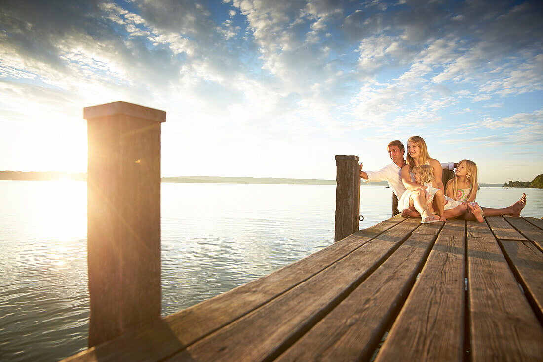 Family on a jetty at lake Starnberg, Upper Bavaria, Bavaria, Germany