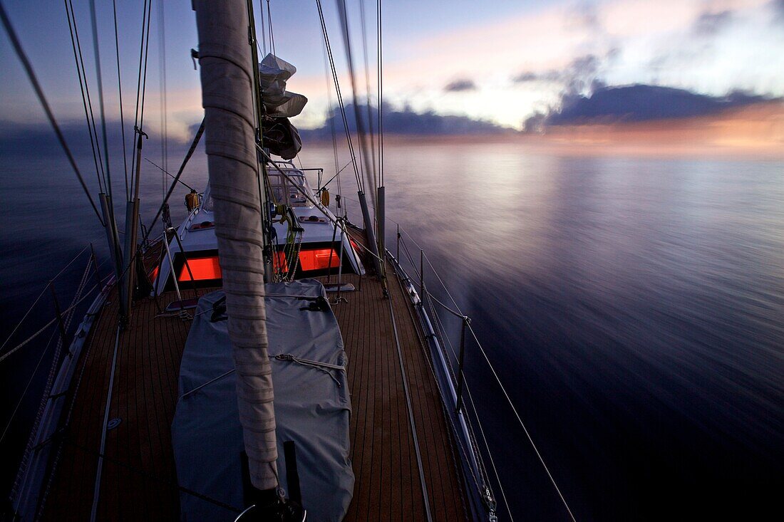 Sailing boat, yacht with night lighting system in the dusk, Sailing