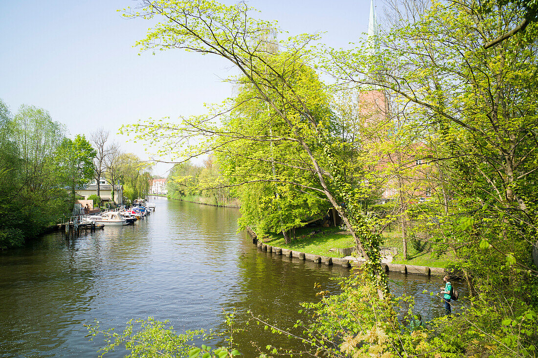 Fishing on the river Trave, Lubeck Cathedral, Lubeck, Schleswig-Holstein, Germany