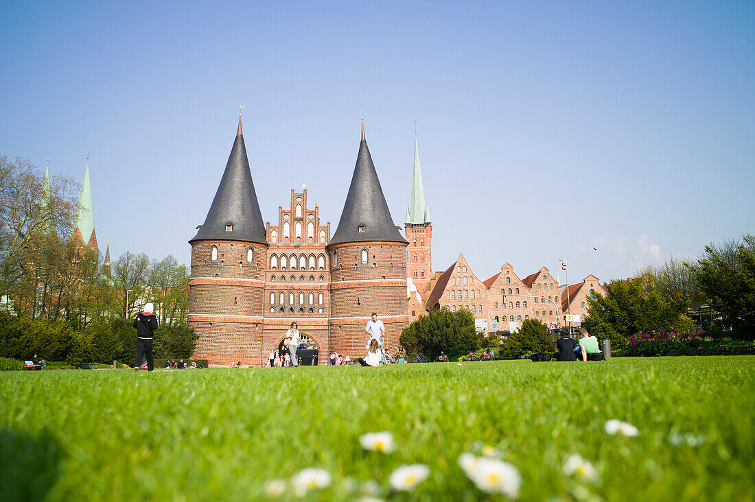 Holsten Gate with salt storehouses and churches of St. Peter and St. Mary in background, Lubeck, Schleswig-Holstein, Germany