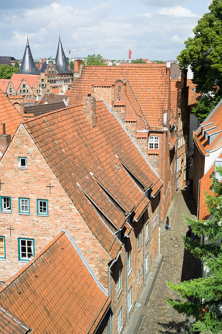 View over historic city with Holsten Gate in background, Lubeck, Schleswig-Holstein, Germany