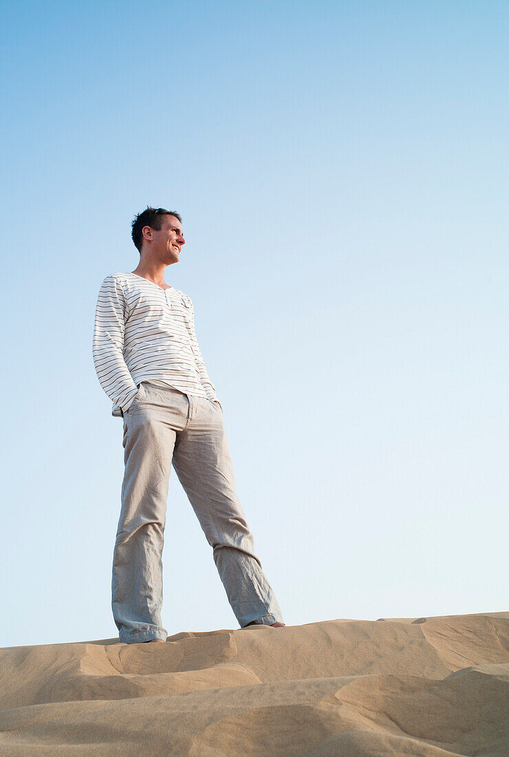 Man on dune in a desert, Dubai, United Arab Emirates