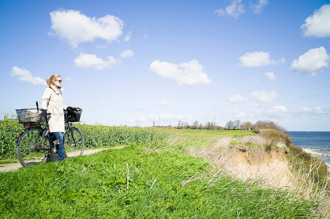 Cyclist on cliff, Neustadt in Holstein, Schleswig-Holstein, Germany