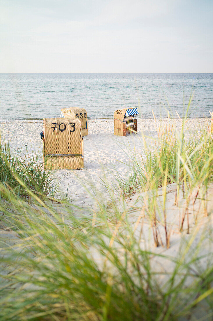 Roofed wicker beach chairs at Baltic Sea beach, Schönberger Strand, Probstei, Schleswig-Holstein, Germany