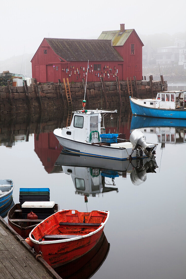 New England, Massachusetts, Close up of small boats in the Rockport Harbor, Red building in background.