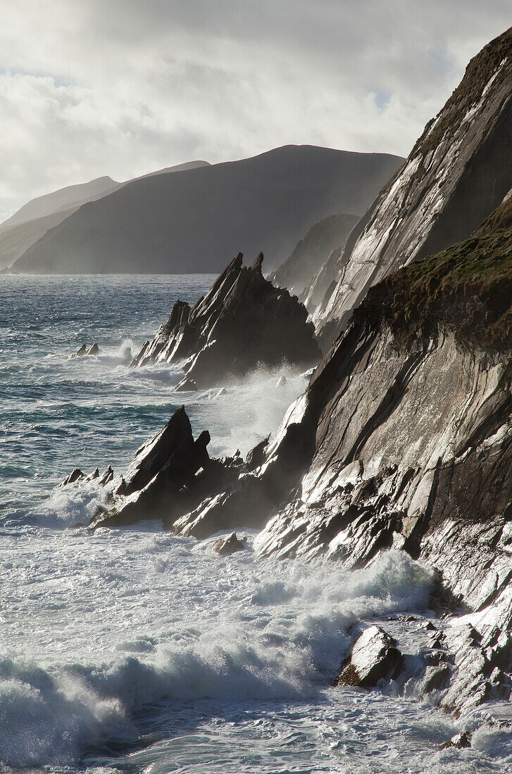 'Waves crash against a rugged coastline, Blasket Islands; County Kerry, Ireland'