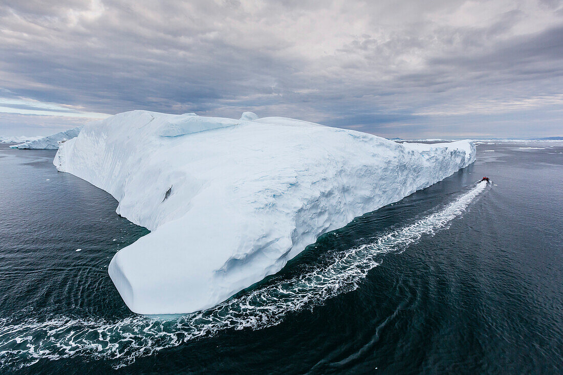 A Zodiac amongst huge icebergs calved from the Ilulissat Glacier, UNESCO World Heritage Site, Ilulissat, Greenland, Polar Regions