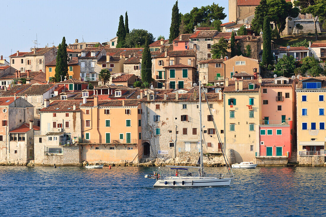 Yacht and Old Town from the sea on a summer's early morning, Rovinj (Rovigno) peninsula, Istria, Croatia, Europe