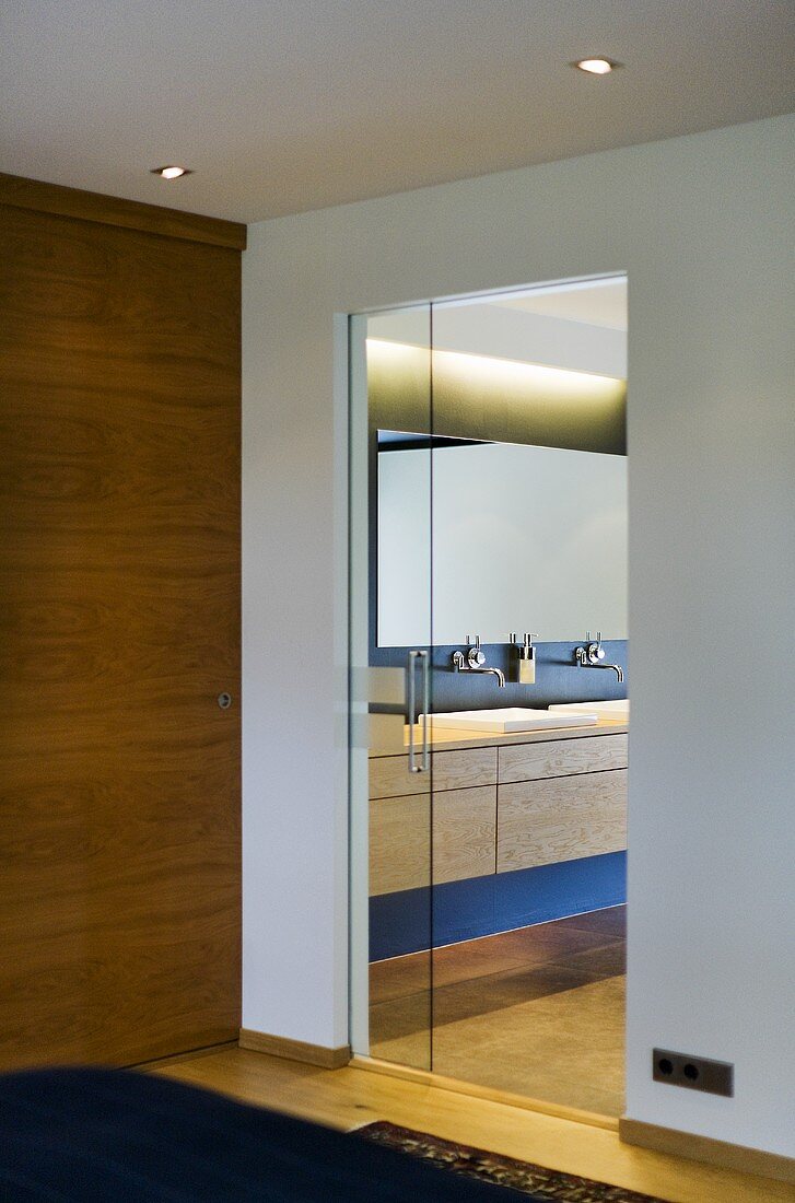 A view through an open door onto the basin in the bathroom