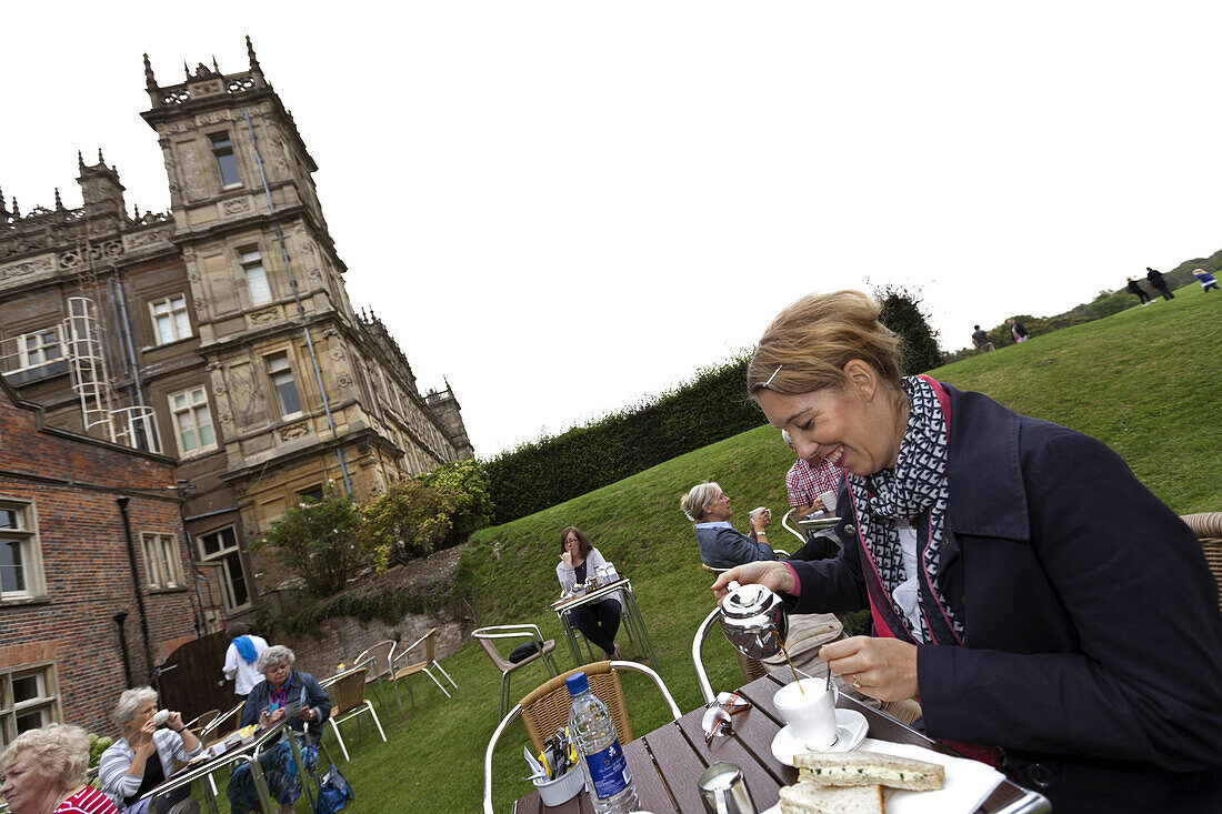 Woman enjoying tea at Highclere Castle, TVs Downton Abbey, Newbury, West Berkshire, England, United Kingdom