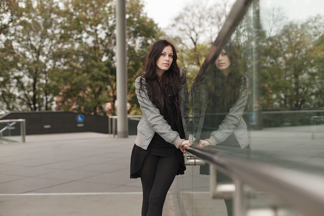 Young woman at a balustrade, Munich, Bavaria, Germany