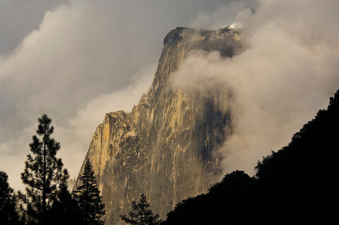 Half Dome emerges from storm clouds at sunset, Yosemite Valley, Yosemite National Park, California