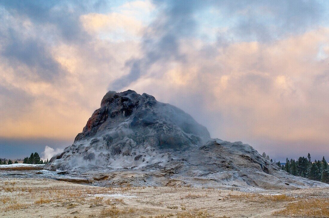 Steam venting from White Dome Geyser and autumn storm clouds at sunrise, Yellowstone National Park, Wyoming