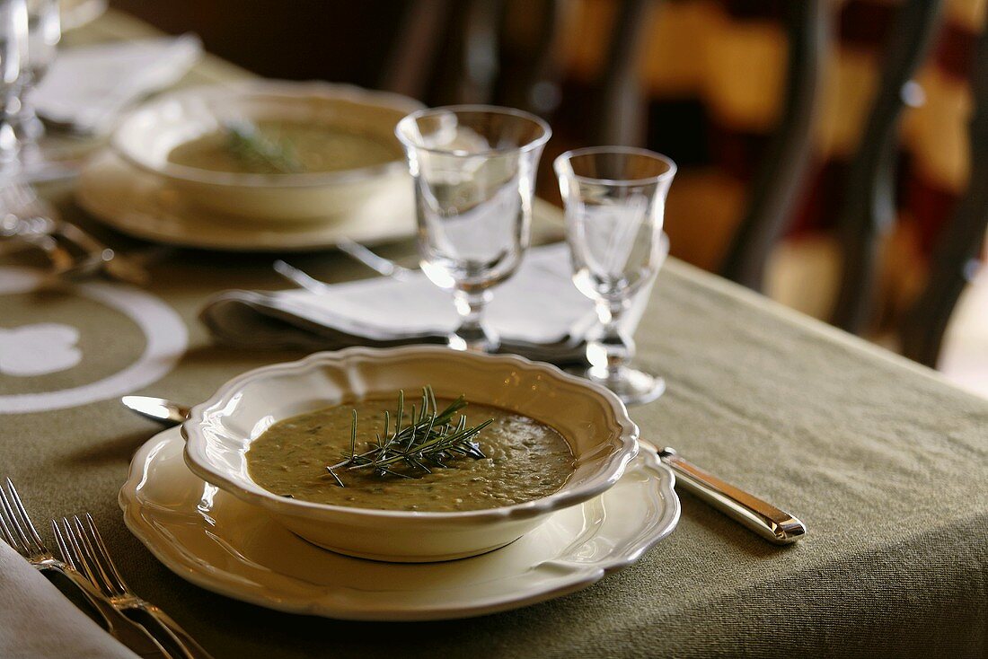 Vegetable soup with rosemary on a table