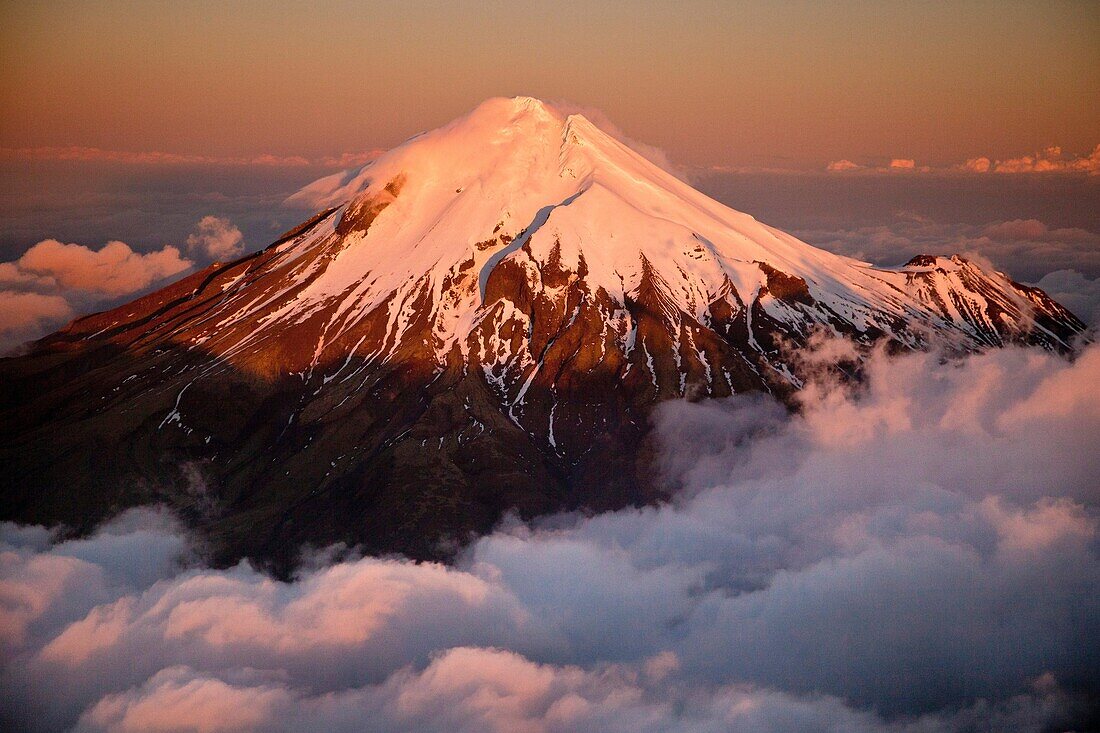 Mt Egmont / Taranaki, western flanks of dormant volcano above evening cloud, sunset, Taranaki.