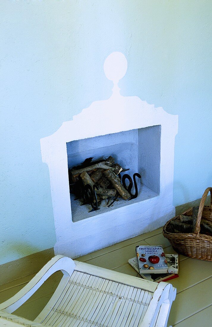 Mock fireplace -- wall niche with a stack of wood in a blue wall