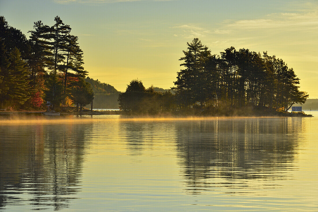 Reflections in Penage/Panache Lake at dawn near the Penage/Panache Lake marina, Greater Sudbury (Penage Lake area), Ontario, Canada.