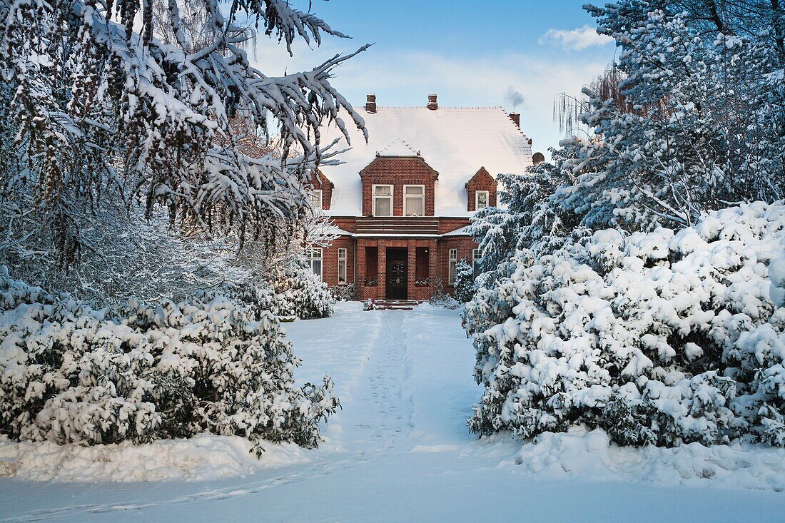 Snow covered house in Heiligenfelde, Lower Saxony, Germany, Europe