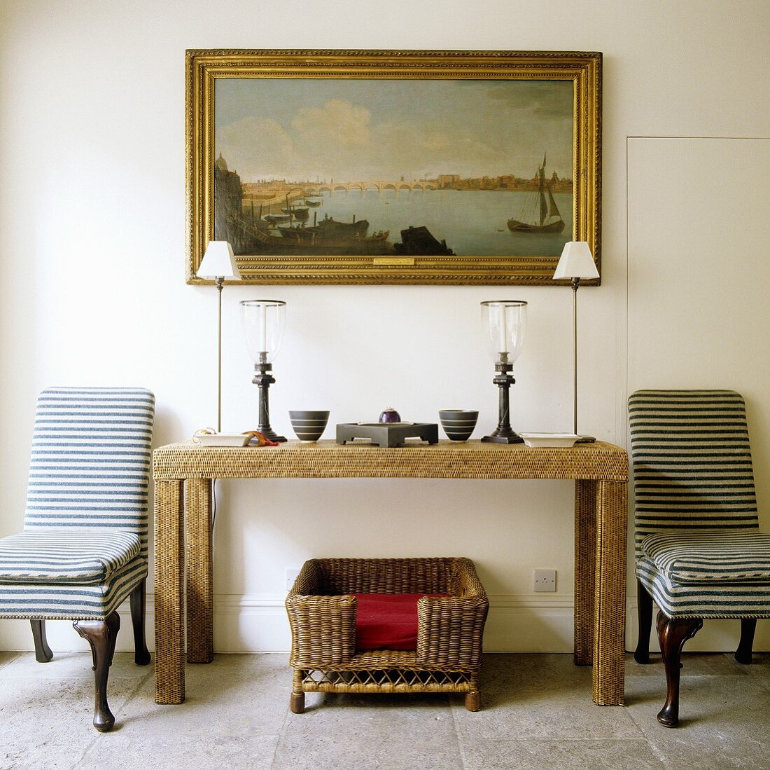 Rustic wooden sideboard, with table lamps and two black and white striped chairs