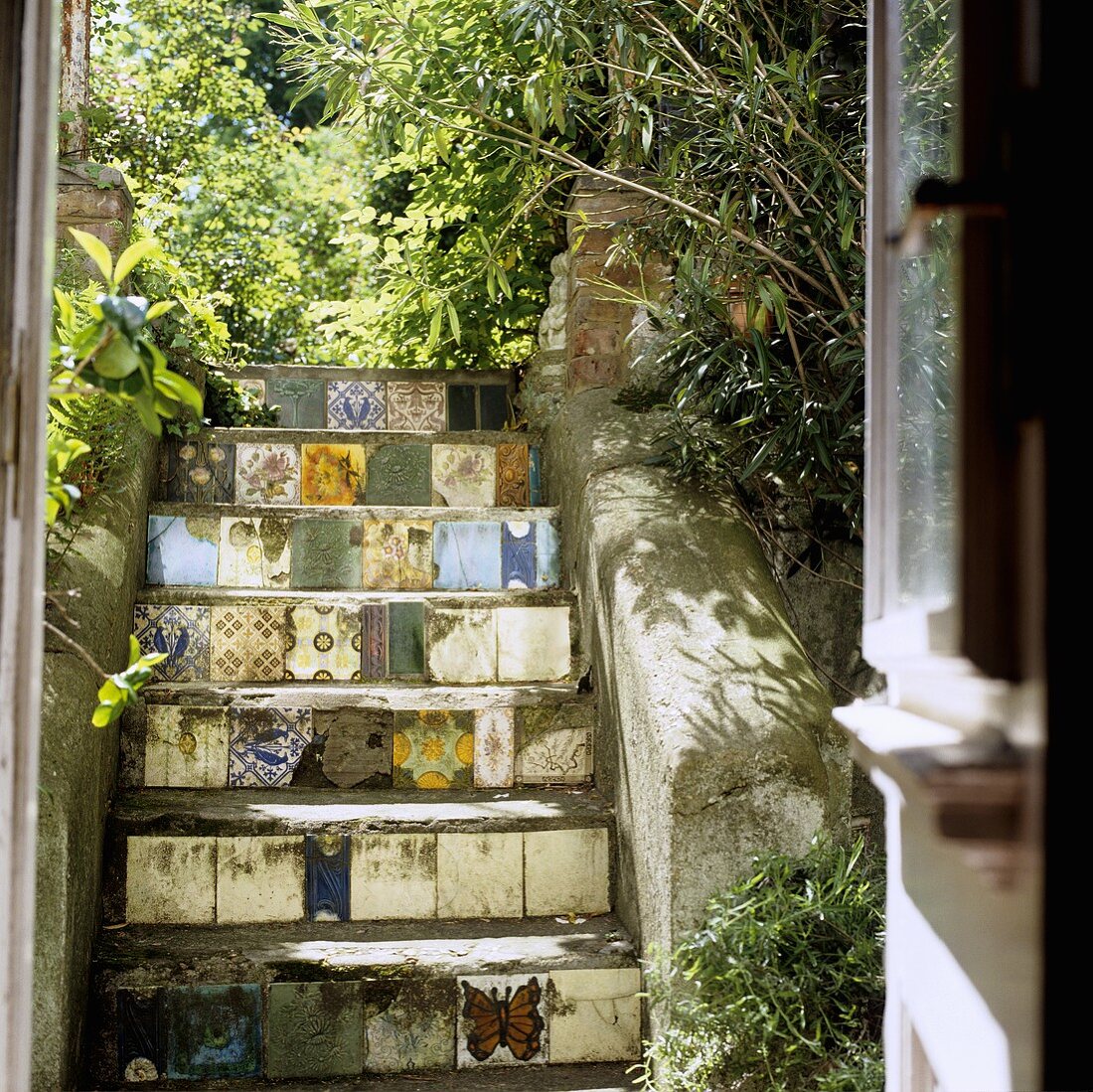 Steps decorated with various tiles in a rear courtyard