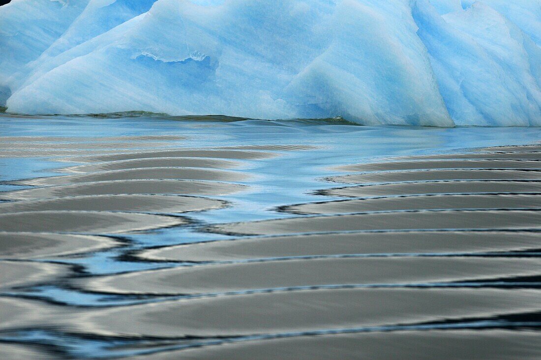 Waves reflected in the calm water of an Iceberg calved from the LeConte Glacier just outside Petersburg, Southeast Alaska, USA  Pacific Ocean