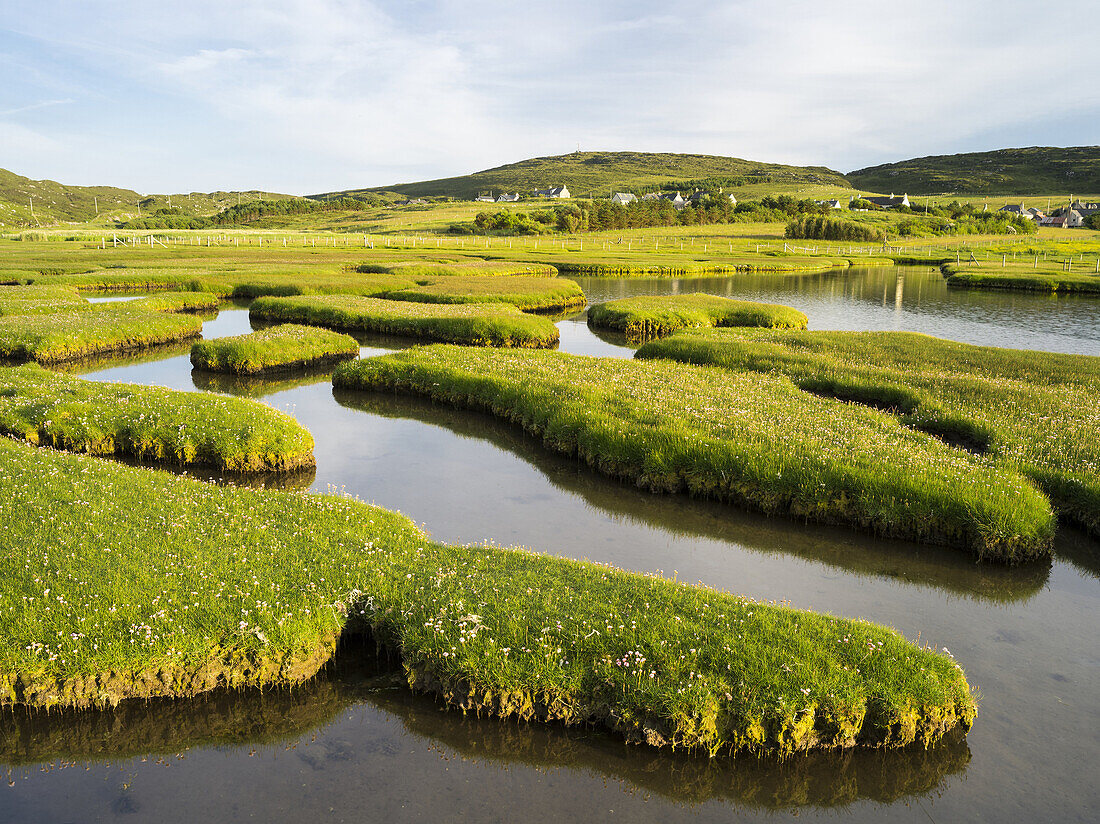 Isle of Harris, part of the island Lewis and Harris in the Outer Hebrides of Scotland. The coastal salt marsh near Northton during sunset. Europe, Scotland, July.