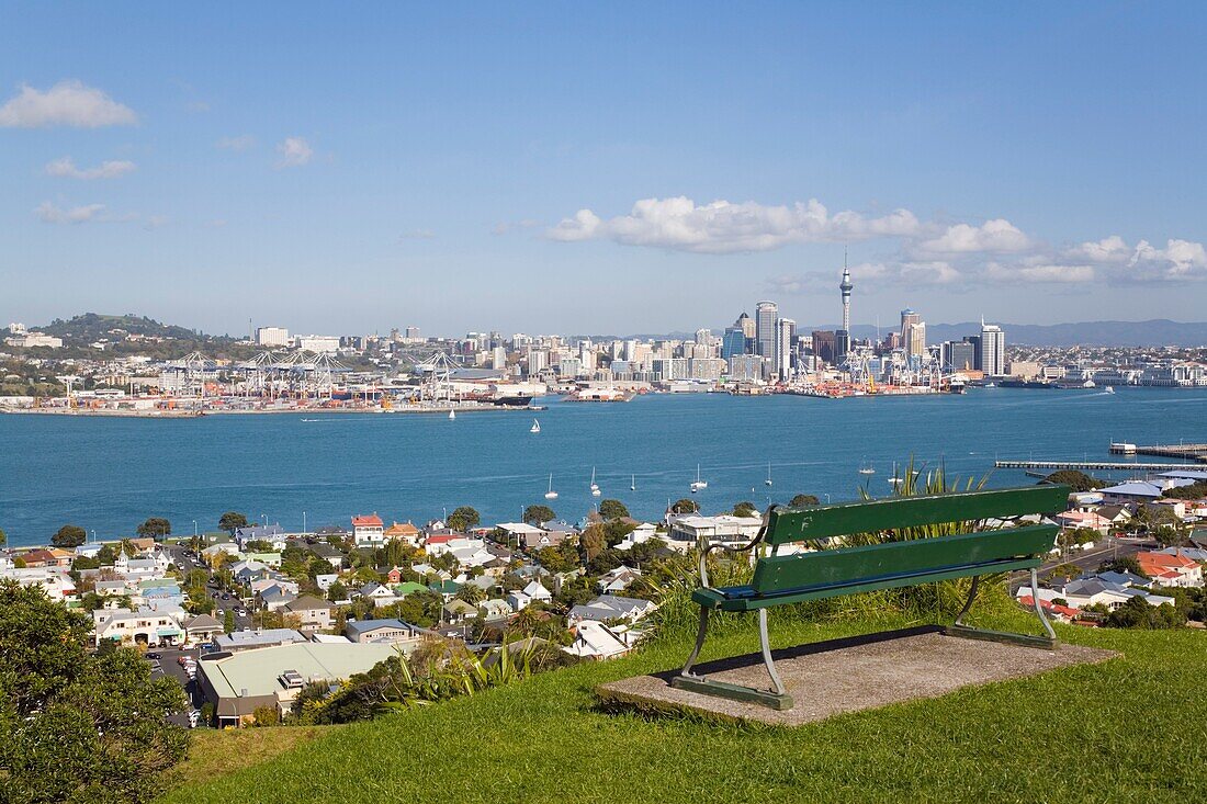 Devonport, North Shore, Auckland, North Island, New Zealand  Bench seat on Mount Victoria with view to Auckland eastern city skyline across Waitemata Harbour