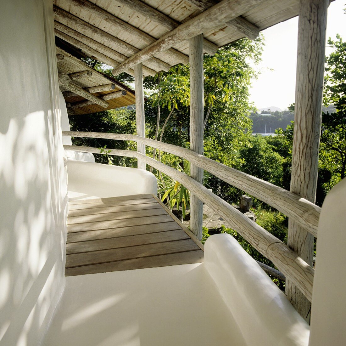 A house with a rustic covered balcony and view of the garden