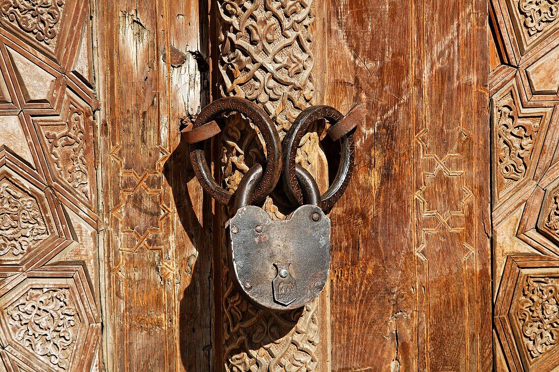Carved wooden door and lock at the Abdullah Khan Medressa, Bukhara, Uzbekistan