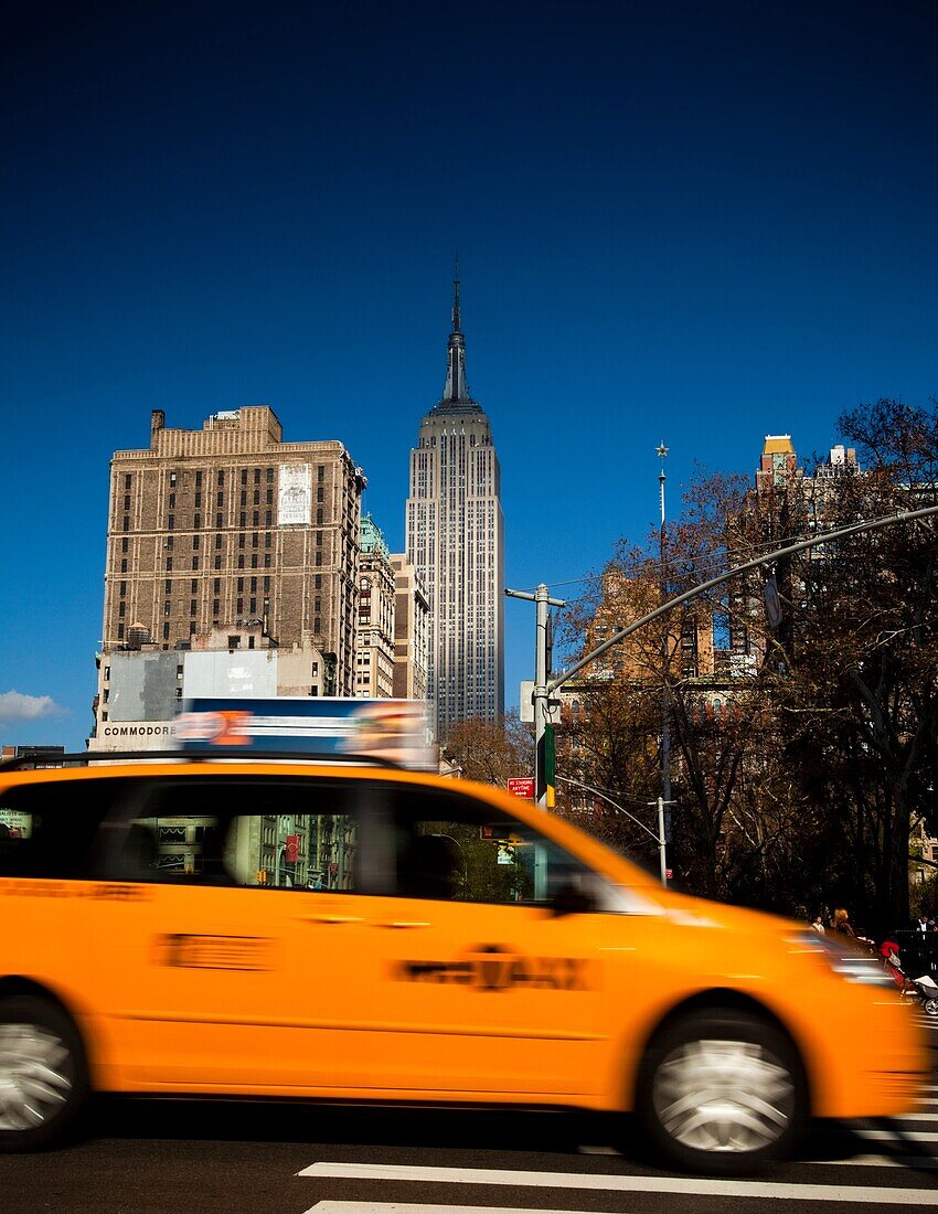 Typical NYC Yellow taxi, Empire State Building in Background.