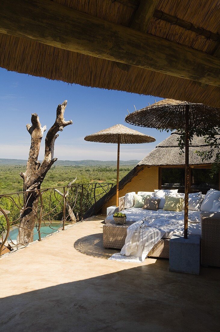 A South African terrace with bamboo sunshades and comfortable loungers