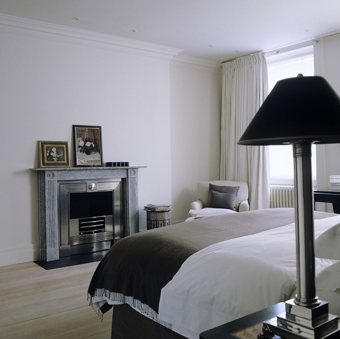 White bedroom with fireplace