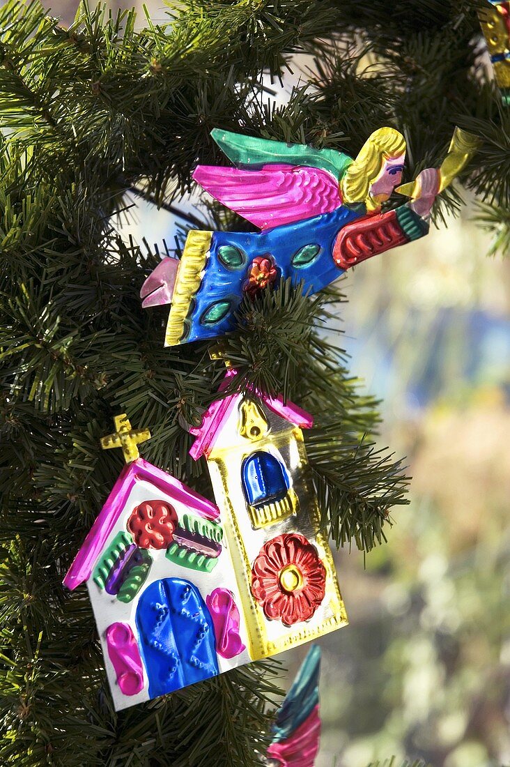 Metal Christmas decorations on a branch of a Christmas tree