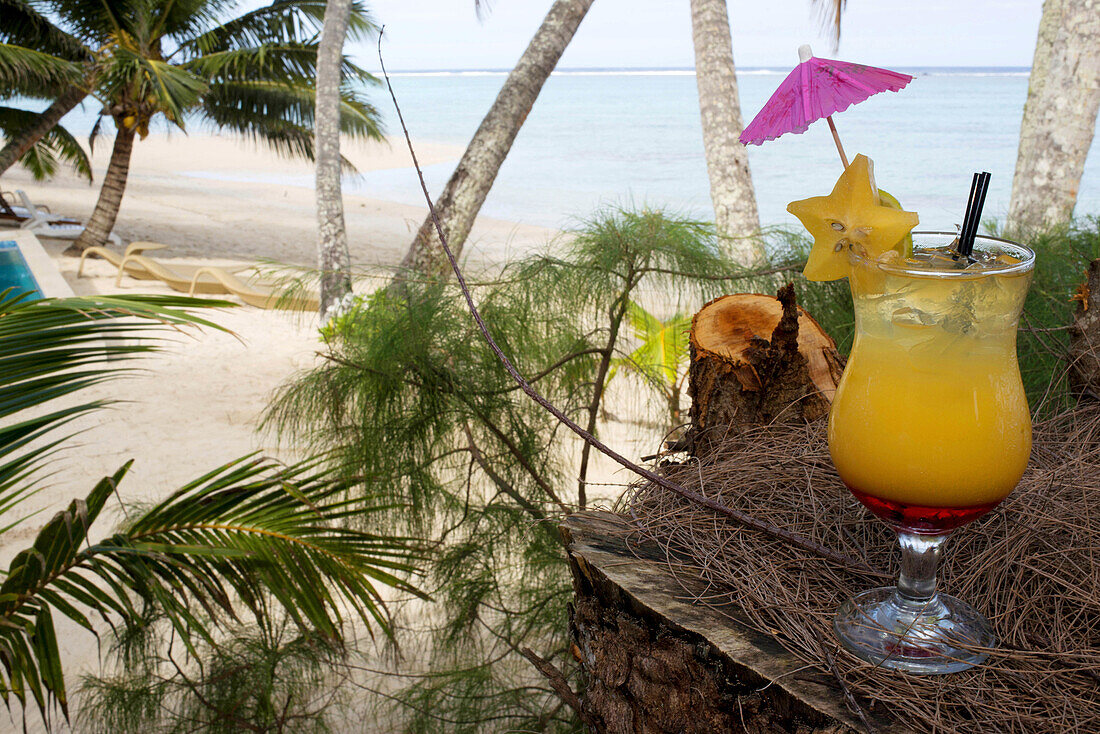 Rarotonga Island. Cook Island. Polynesia. South Pacific Ocean. A waitress serves delicious next to the poolside at the luxurious Little Polynesian Resort in Rarotonga. Nestled on the southern tip of Rarotonga, Little Polynesian Resort is a sophisticated p