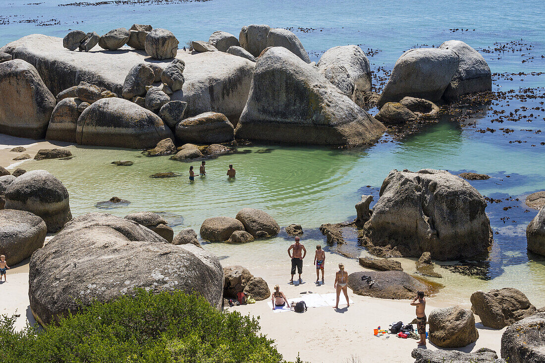 Tourist and locals enjoy protected shallow ocean water, Boulders Beach National Park, Simonstown, South Africa.