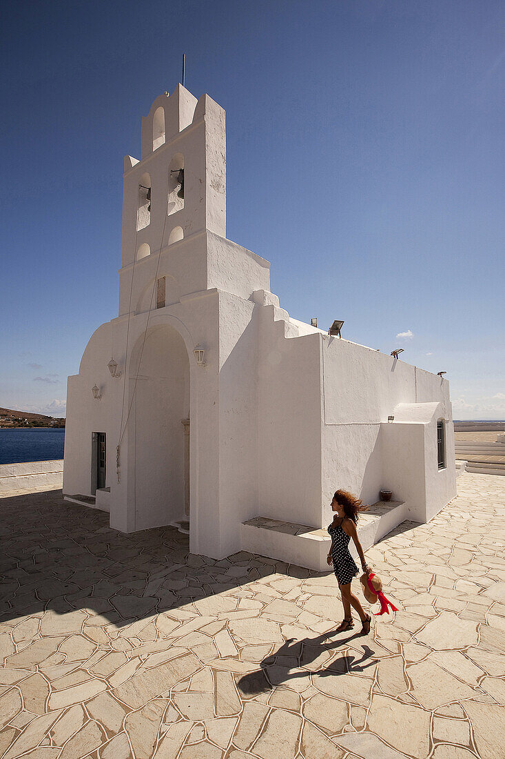 Woman in front of the Chrisopigi monastery, Sifnos, Cyclades Islands, Greek Islands, Greece, Europe.