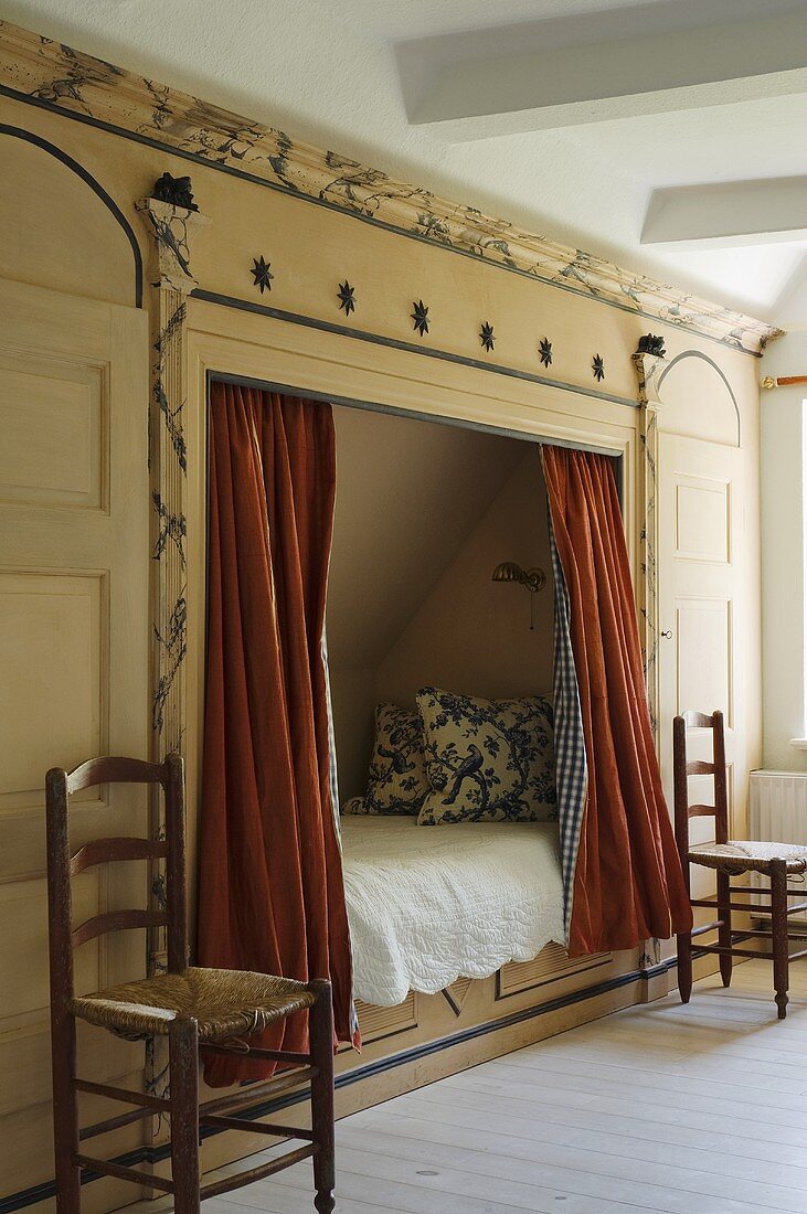 An alcove with red curtains in a bedroom in country house