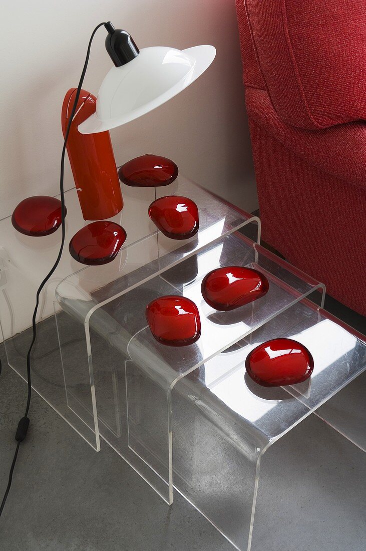 Three acrylic nesting tables decorated with red glass stones