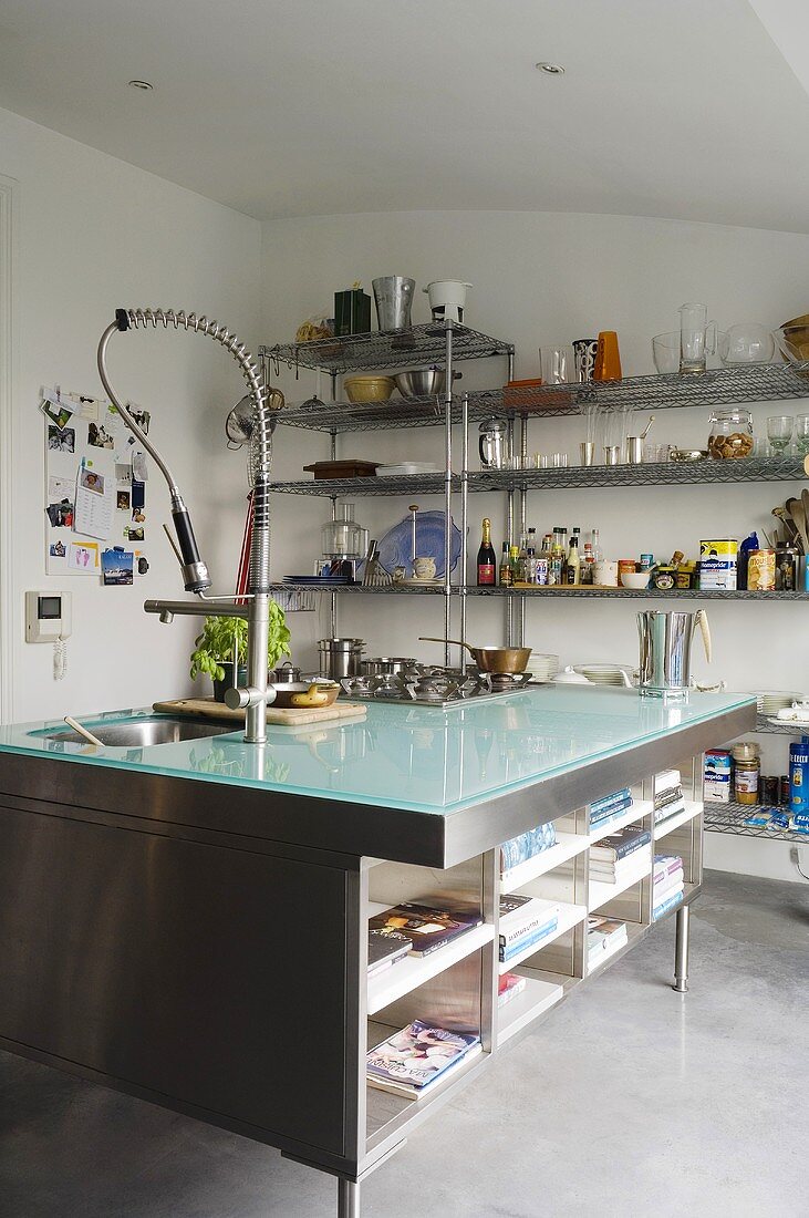 Cool materials - a glass-topped kitchen counter with a built-in stainless steel shelf with a modern tap