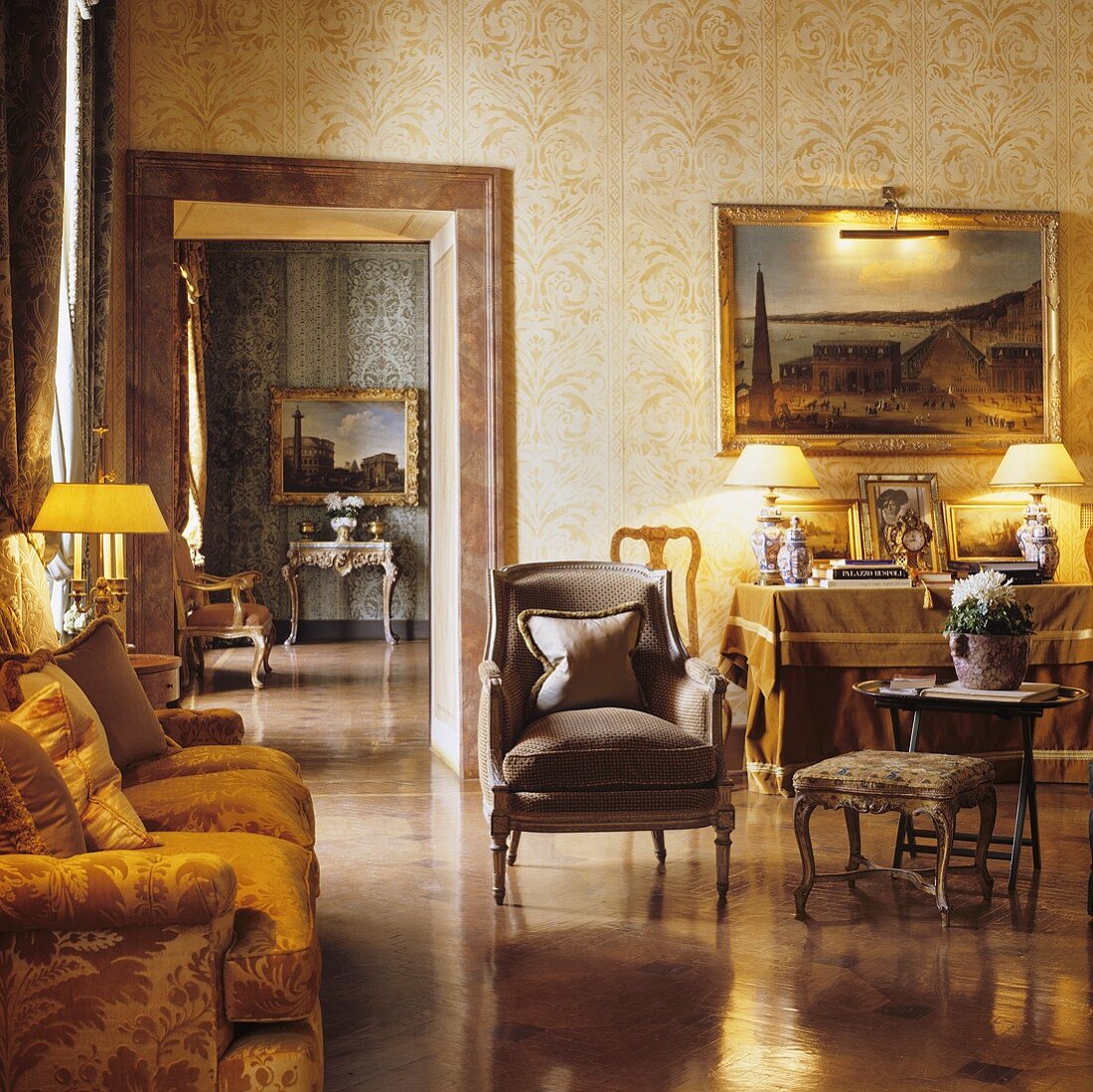 A living room in a palazzo with antique seats bathed in warm artificial light