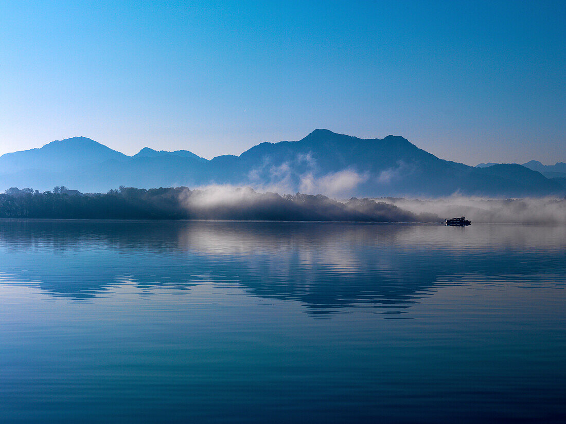 Herreninsel and mountains Hochfelln and Hochgern in morning fog, lake Chiemsee, Bavaria, Germany