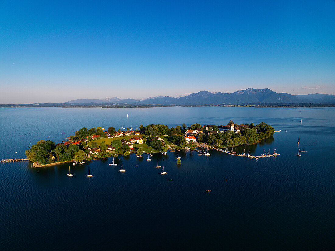 Aerial shot of Fraueninsel, Chiemgau Alps in background, lake Chiemsee, Bavaria, Germany
