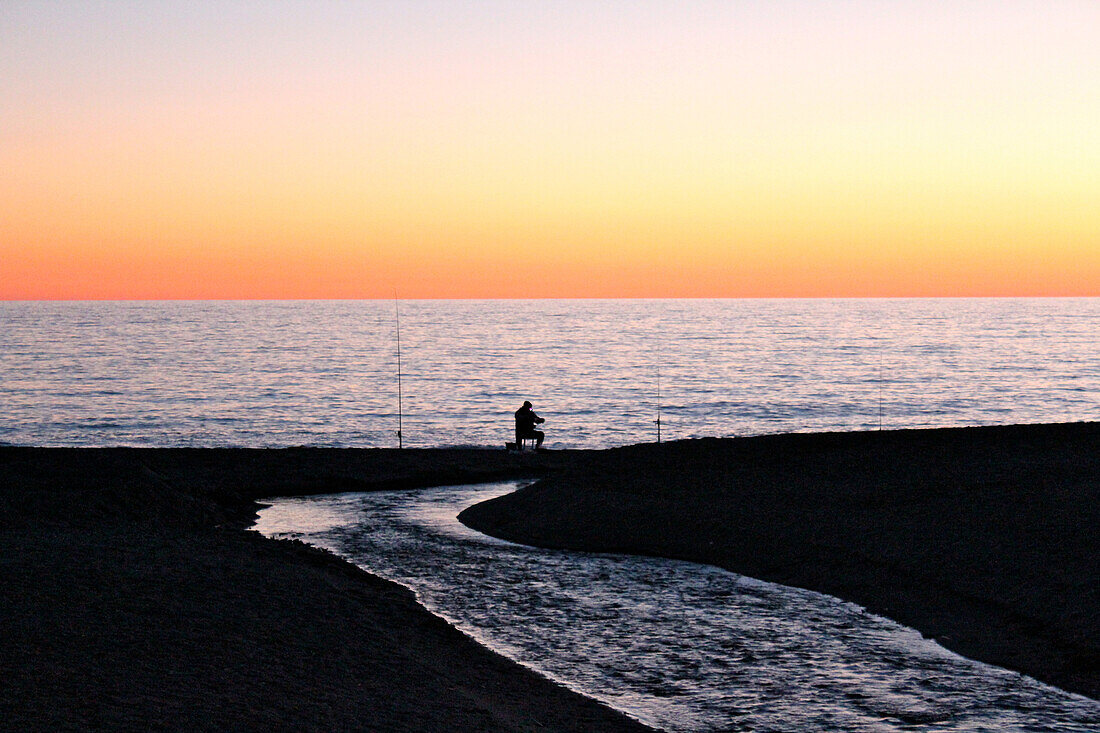 Angler at beach in sunset, Salobrena, Costa Tropical, Andalusia, Spain